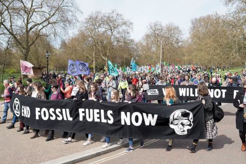 Extinction Rebellion supporters exit Hyde Park as they march across central London towards the River Thames. 